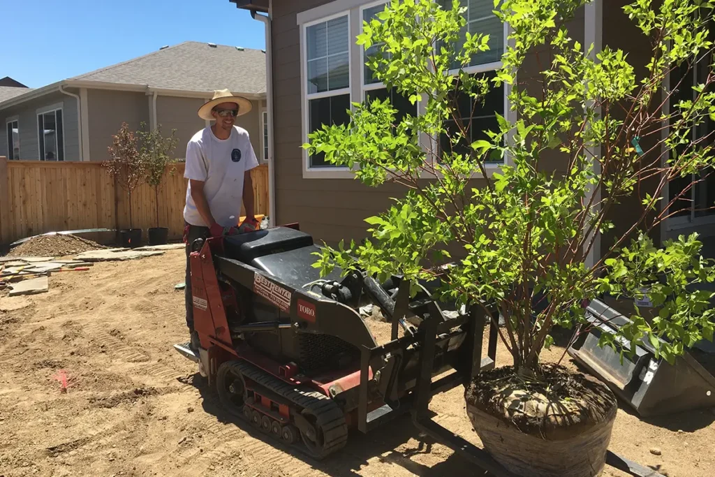 Stuart Shoemaker moving a tree with heavy machinery