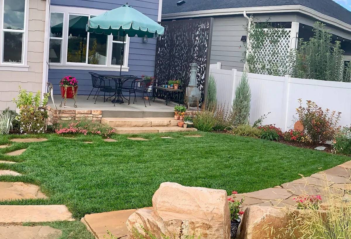 Blue Spruce Horticulture professionals installing plants, creating stunning flagstone landscapes, and setting up irrigation sprinklers.