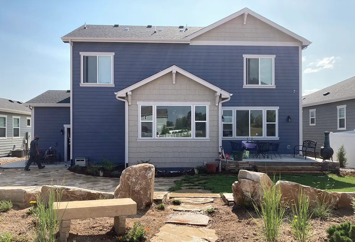 Blue Spruce Horticulture professionals setting up plants, landscaping, and irrigation systems in backyard of a home in Colorado.