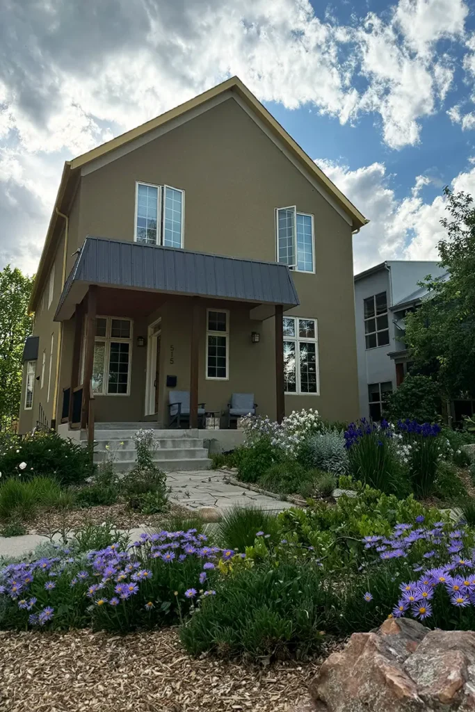 Front of home with a native garden and purple flowers blooming on Whitcomb Street.